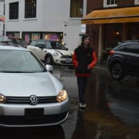 <p>A car pulls up to the valet parking station outside Bedford Square on a rainy Thursday in downtown Westport.</p>