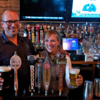 <p>Clock Tower Grill Owners Rich and Cassie Parente serve up a variety of craft beers.</p>