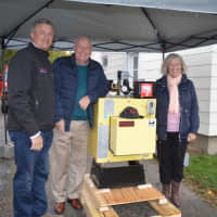 <p>Sam Gault, left, introduced Willie and Anne Salmond to their new home heating system, valued at $11,000.</p>