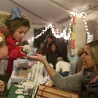 <p>A little girl and her dad shop at the Rowayton Historical Society&#x27;s Holiday Bazaar, part of the Light Up Rowayton event on Sunday.</p>