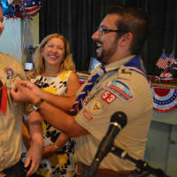 <p>Scoutmaster Peter Marks and Jeremy Fine share smiles as the latter receives his Eagle Scout pin</p>