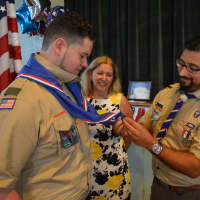<p>Scoutmaster Peter Marks bestows the Eagle neckerchief upon Jeremy Fine.</p>