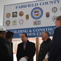 <p>Bridgeport Mayor Joe Ganim, third from left, chats with city leaders and Gary Flocco, CEO of Corvus Capital Partners, which is developing the new Cherry Street Lofts.</p>