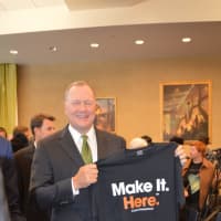 <p>Sikorsky President Dan Schultz holds up the new T-shirt he received Monday at Housatonic Community College.</p>