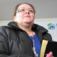 <p>Geovana Pimentel clutching a Bible, written in Spanish. Gifting new homeowners with holy books is a Habitat for Humanity tradition.</p>