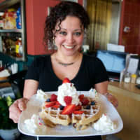 <p>Owner Carina Evangelista with one of the signature waffles from Frankie&#x27;s.</p>