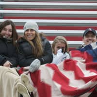 <p>Fans try to stay warm in the stands Thursday in Bedford.</p>