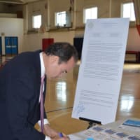 <p>Bridgeport Mayor Joe Ganim signed a petition against proposed cuts to federal funding Tuesday.</p>