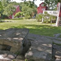<p>A historic rock-slab picnic table graces the yard at Weir Farm.</p>