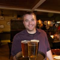 <p>Manager Matt Mitchell delivers a tray of craft suds.</p>