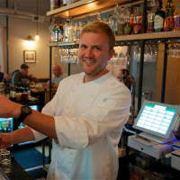 <p>The Hop Owner John Kelly draws a craft beer on tap.</p>