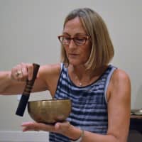 <p>Mary Ann Gebhardt leading a yoga nidra sound healing class in Montvale.</p>