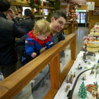 <p>A boy and his dad check out the train at Wilkens Farm.</p>