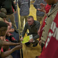 <p>TZ coach George Gaine talks to his team during a timeout.</p>