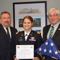 <p>Mahwah Council President Robert Hermansen, Danielle Ullman and Mayor Bill Laforet pose with a flag that flew over Afghanistan, where Ullman served with the U.S. Army.</p>