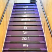 <p>A staircase to the second floor of The Body Image Boutique. Inspirational sayings are everywhere at the new community, located in a former parish house.</p>