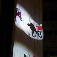 <p>Mrs Claus, The Grinch and Cash Elf rappel down Landmark Square in downtown Stamford.</p>