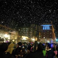 <p>The city of Stamford ushered in the holiday season Sunday night with one of its signature events, Heights &amp; Lights. Here, artificial snow falls from the sky after Santa and his friends rappelled down the Landmark Square Building.</p>