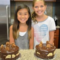 <p>Proud bakers at the end of summer camp show off their creations.</p>