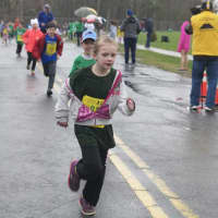<p>Children run for the finish line at the kids race, which steps off before the Sandy Hook 5K.</p>