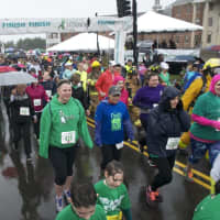 <p>Runners make their way across the start line at Saturday&#x27;s 5K.</p>