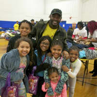 <p>Washington Redskins RB Silas Redd (top) with some of the kids at Saturday&#x27;s Clothing Drive &amp; Swap at the Carver Center in Norwalk.</p>