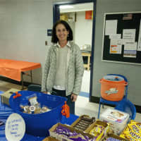 <p>A volunteer sells snacks at the concession stand.</p>