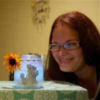 <p>Brittany Gregorio and son Jayden with the Glow Jars they teamed up to create.</p>