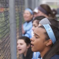 <p>Ursuline players cheer from the dugout.</p>