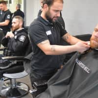 <p>Sitting for a shave are Sgt. Chris Donaldson, foreground, with Evan Vidal, owner of The Shave Shop.  Behind him are, right to left, Officer Corey Rooney, Det. Sgt. Adam Hampton, and Officer Thomas Smith.</p>