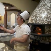 <p>Amore&#x27;s pizza chef spins up a pie.</p>