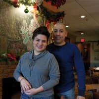 <p>Owner Mario Espana and his daughter, Ally, in front of the restaurant&#x27;s warmly decorated fireplace.</p>
