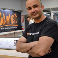 <p>New Boost Mobile: Oscar M. Galdamez, owner of the Boost Mobile on North Washington Avenue, in the newly designed store on the eve of the reopening.</p>