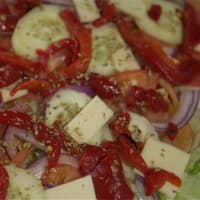<p>The salad pizza is packed with veggies.</p>