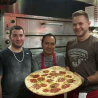 <p>The staff at Napoli&#x27;s Pizza shows off a Margherita pie.</p>