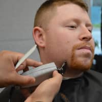 <p>Hillsdale Police Officer Alex Kaplan loses his beard at the Shave Off.</p>