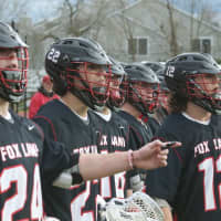 <p>Fox Lane players look on from the sideline.</p>