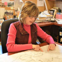 <p>Architect Linda Del Nobile Menze reviewing a blueprint in her Park Ridge office.</p>
