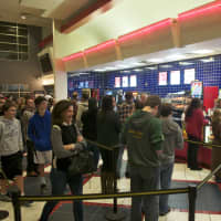 <p>A line of people wait to buy tickets for &#x27;Star Wars&#x27; on Thursday evening in Stamford. </p>