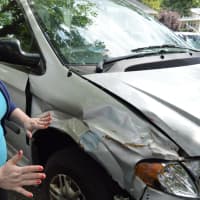 <p>Melissa Deyoung pointing out the damage done to the van she uses to drive around her disabled son.</p>