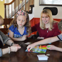 <p>Lesley Linker, second from right, plays an after-school game with her mom, Marsha Ellis, and her two children.</p>