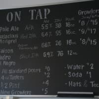 <p>A chalkboard lists the beers on hand.</p>