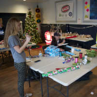 <p>Teens work on wrapping gifts at the Teen Center. </p>