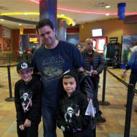 <p>A family heads in to see Star Wars: The Force Awakens.</p>