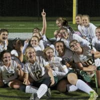 <p>The Hornets celebrate in the goal after beating Rye in the Class B title game.</p>