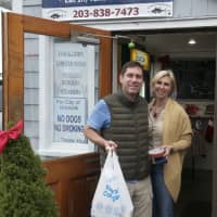 <p>Happy customers leave Rowayton Seafood on Christmas Eve with fixings for a feast.</p>