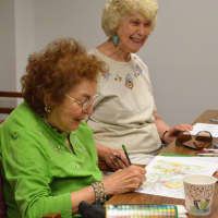 <p>Joan Endrigo, of Ramsey, left, and Lorraine Harburg, of Franklin Lakes, enjoy a light moment while coloring in Oakland.</p>