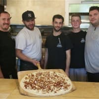<p>Some of the staff at Froggy&#x27;s with one of their pies.</p>