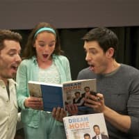 <p>The Property Brothers - Jonathan Scott (L) and Drew Scott - clown around with a fan at Monday&#x27;s book signing.</p>