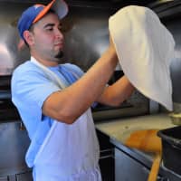 <p>Pedro Constanza of Ridgewood working the dough.</p>